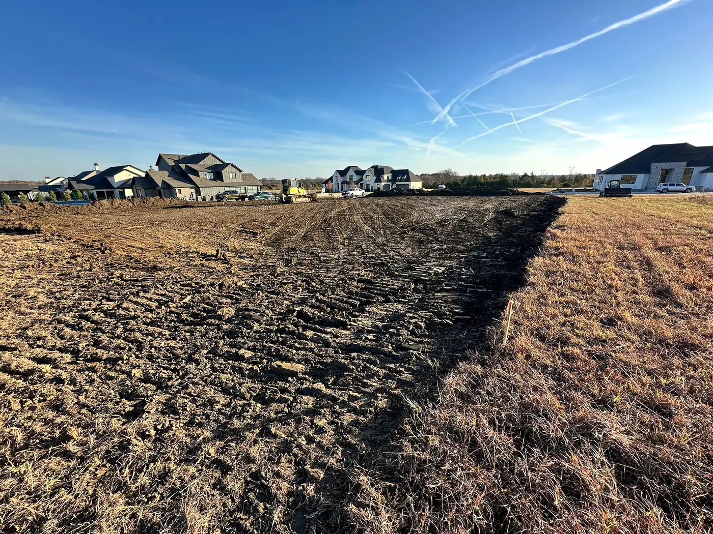 Dozer performing rough grading on a large lot