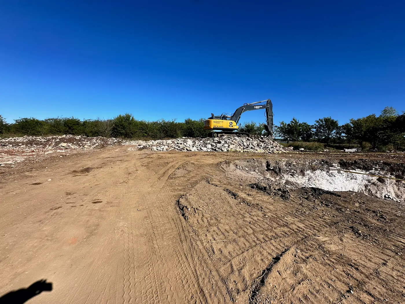 Excavator moving rock during site excavation