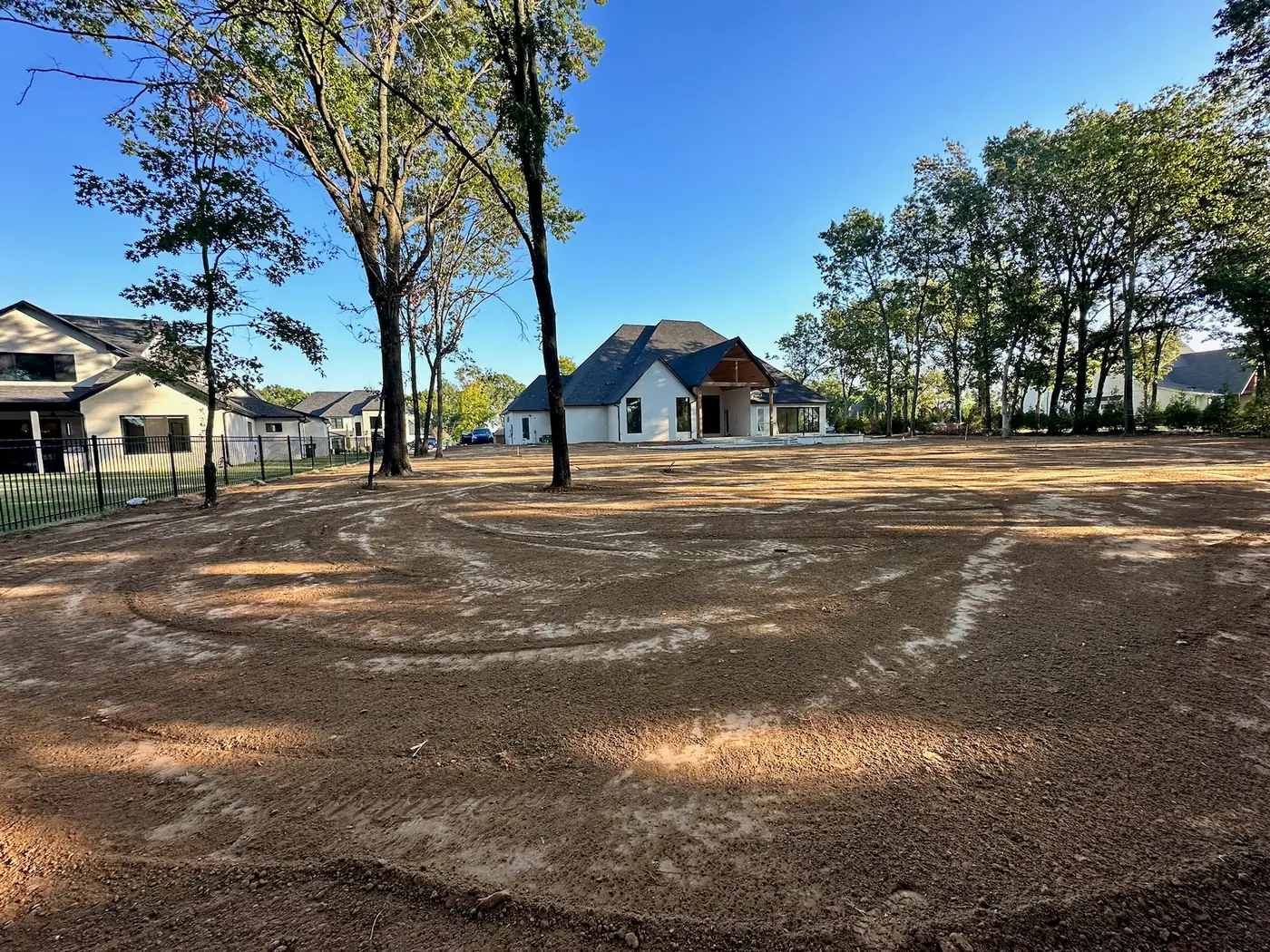 Finished grading around a completed residence