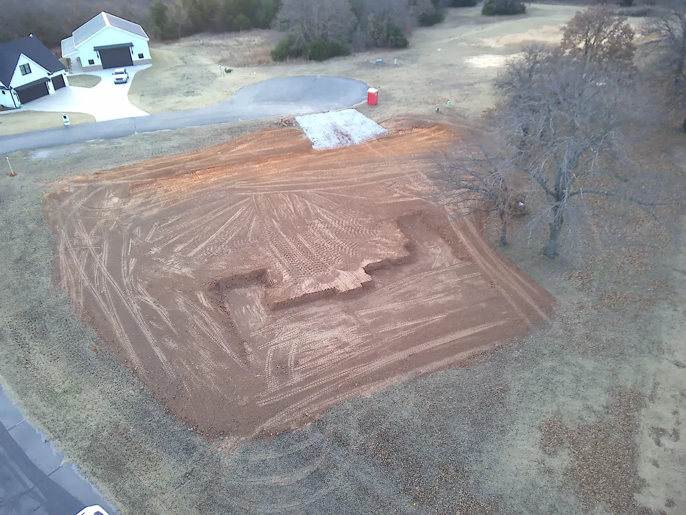 Aerial view of a compacted red-dirt building pad